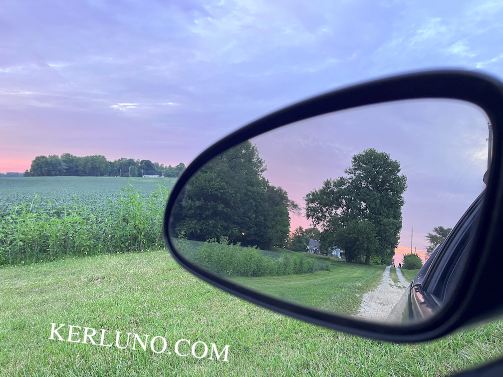 Landscape with the view in the car mirror.
